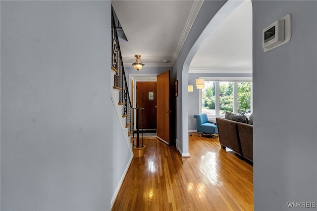 66 Devonshire Rd, Tonawanda, NY 14223 - corridor with arched walkways, hardwood / wood-style floors, ornamental molding, and stairs