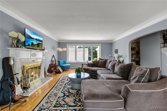 66 Devonshire Rd, Tonawanda, NY 14223 - living room with arched walkways, a fireplace, crown molding, and wood finished floors