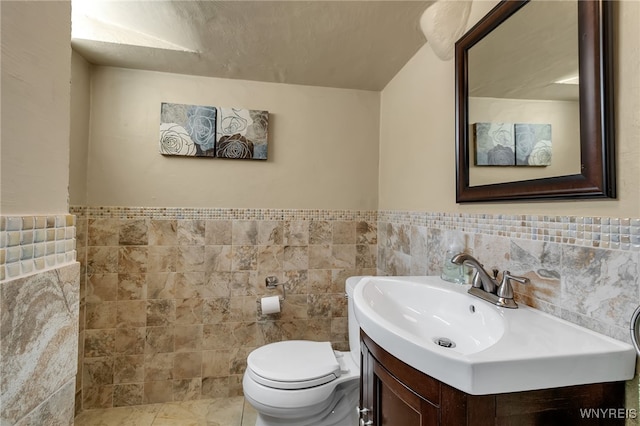 66 Devonshire Rd, Tonawanda, NY 14223 - bathroom featuring tile walls, vanity, and a wainscoted wall