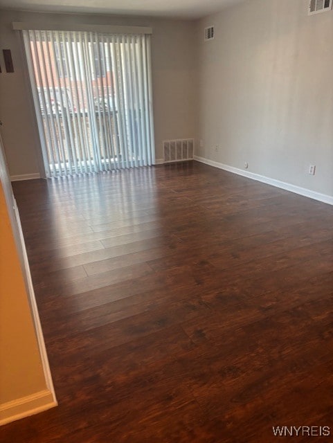 770 W Ferry St Unit 9A, Buffalo, NY 14222 - spare room with baseboards and dark wood-type flooring
