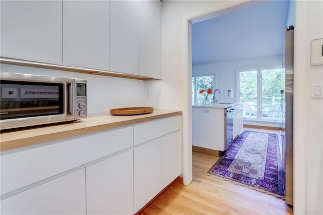 56 Waterview Cir, Penfield, NY 14625 - kitchen with appliances with stainless steel finishes, modern cabinets, light countertops, and light wood-style floors