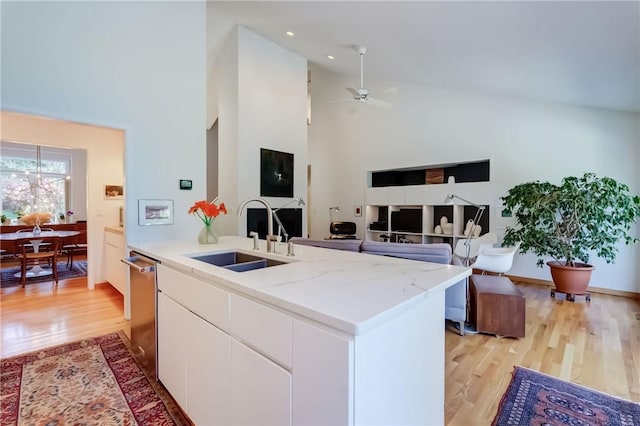 56 Waterview Cir, Penfield, NY 14625 - kitchen featuring light wood-style flooring, white cabinets, light stone countertops, dishwasher, and high vaulted ceiling