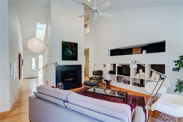 56 Waterview Cir, Penfield, NY 14625 - living area featuring a fireplace, a towering ceiling, light wood finished floors, and ceiling fan