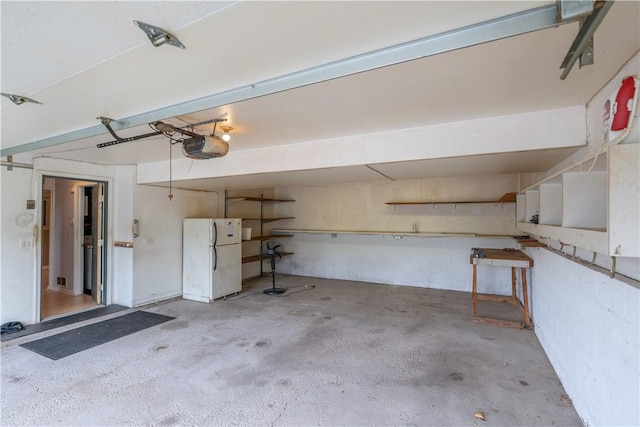 5 Yankee Ct, Chili, NY 14624 - garage featuring freestanding refrigerator and a garage door opener