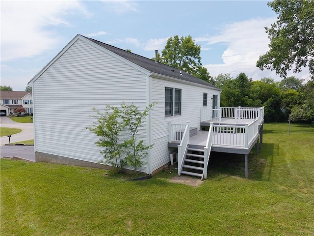 5 Yankee Ct, Chili, NY 14624 - rear view of house with a deck and a lawn