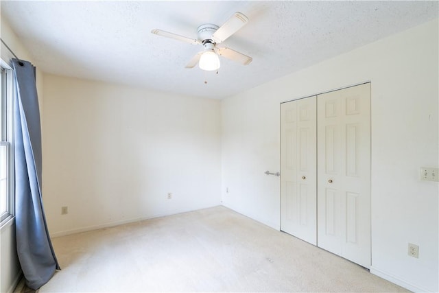5 Yankee Ct, Chili, NY 14624 - unfurnished bedroom featuring light colored carpet, a closet, and ceiling fan