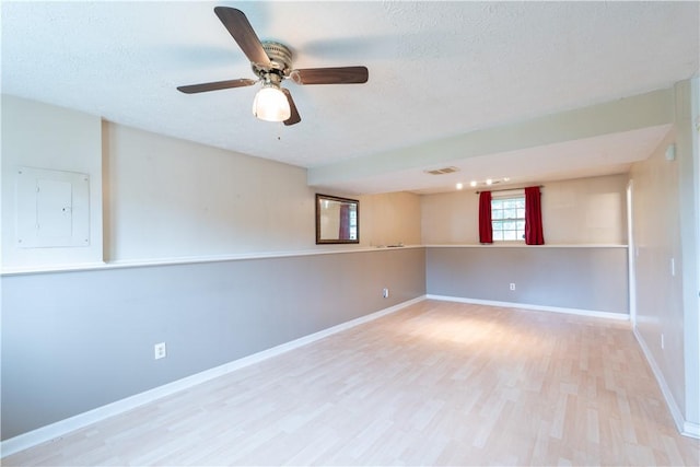5 Yankee Ct, Chili, NY 14624 - spare room featuring electric panel, wood finished floors, a textured ceiling, and a ceiling fan