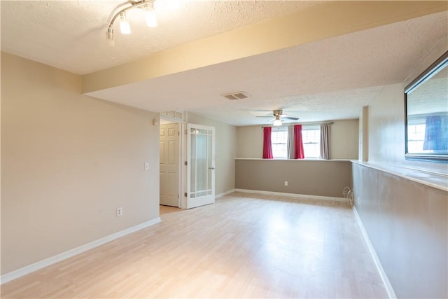 5 Yankee Ct, Chili, NY 14624 - empty room with a textured ceiling, light wood-type flooring, and ceiling fan