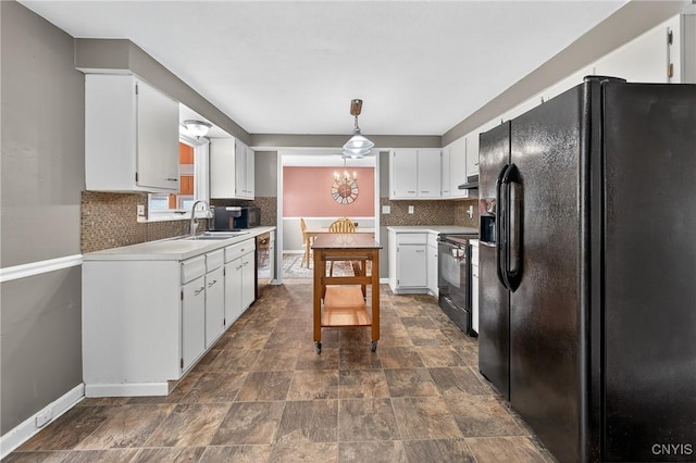 5647 Stevens Dr S, Cicero, NY 13039 - kitchen featuring black appliances, decorative backsplash, light countertops, under cabinet range hood, and white cabinets