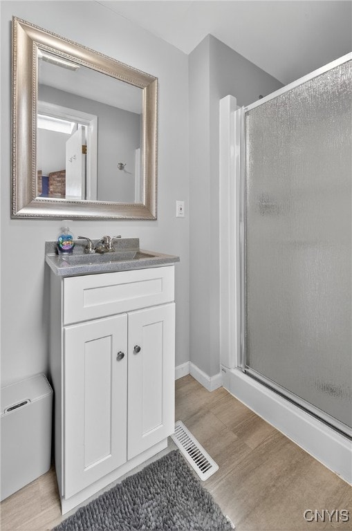 5647 Stevens Dr S, Cicero, NY 13039 - full bathroom with wood finished floors, a shower stall, and vanity