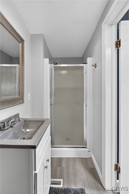 5647 Stevens Dr S, Cicero, NY 13039 - full bath with wood finished floors, vanity, and a stall shower