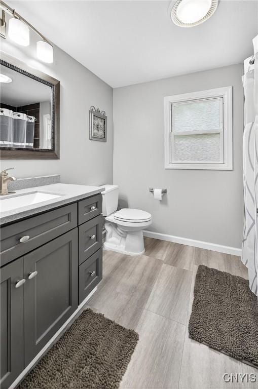 5647 Stevens Dr S, Cicero, NY 13039 - full bath with vanity, wood finished floors, and a shower with shower curtain