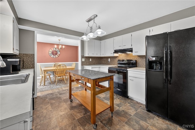 5647 Stevens Dr S, Cicero, NY 13039 - kitchen featuring black appliances, under cabinet range hood, tasteful backsplash, a chandelier, and stone finish floors