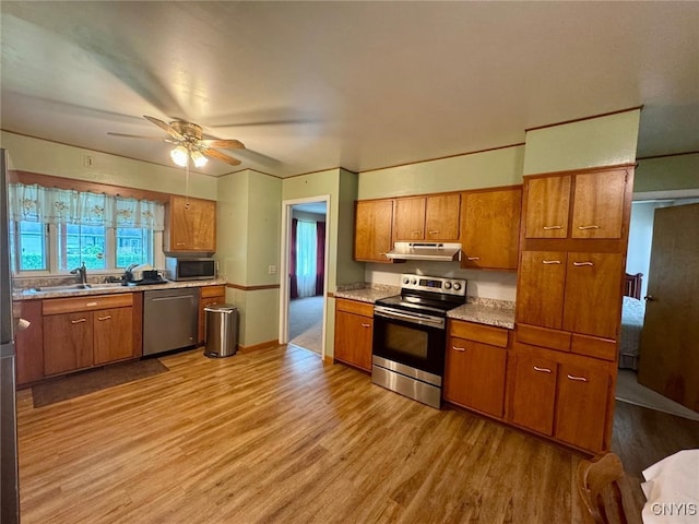 16 Locust Ave, Cortland, NY 13045 - kitchen with appliances with stainless steel finishes, under cabinet range hood, brown cabinetry, and light wood-style floors