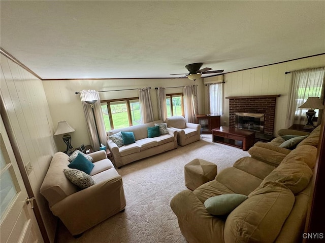 16 Locust Ave, Cortland, NY 13045 - carpeted living room with ceiling fan, ornamental molding, a fireplace, and wooden walls