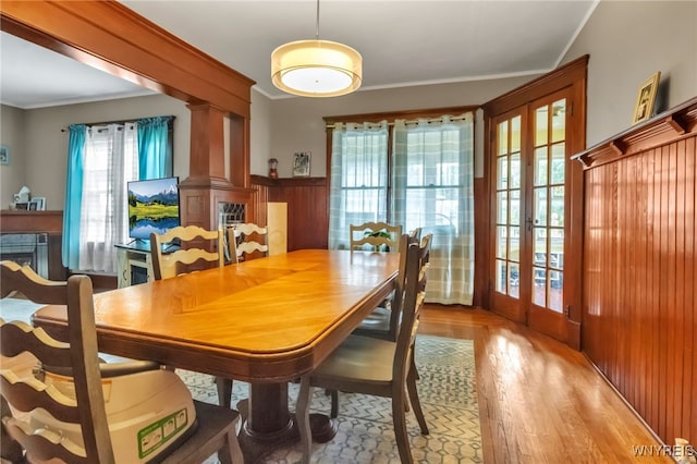 6467 Patchin Rd, Boston, NY 14025 - dining space with french doors, wood finished floors, a fireplace, wainscoting, and ornamental molding