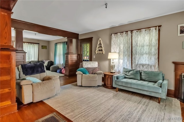 6467 Patchin Rd, Boston, NY 14025 - living area with ornate columns and wood finished floors
