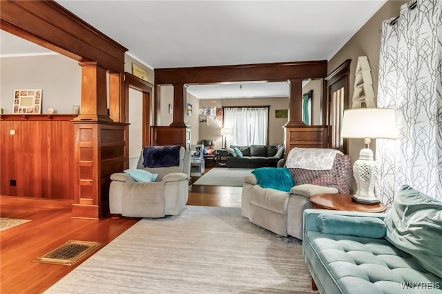 6467 Patchin Rd, Boston, NY 14025 - living area with wood finished floors, decorative columns, and ornamental molding