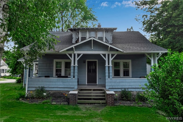 6467 Patchin Rd, Boston, NY 14025 - bungalow-style house with covered porch, a chimney, a front yard, and a shingled roof