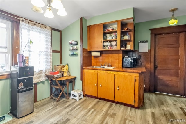 6467 Patchin Rd, Boston, NY 14025 - bar area with light wood-style floors, a chandelier, decorative backsplash, lofted ceiling, and hanging light fixtures