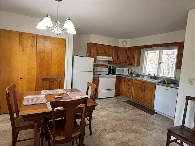 1237 County Highway 11, Davenport, NY 13860 - kitchen featuring white appliances, under cabinet range hood, a chandelier, brown cabinetry, and hanging light fixtures