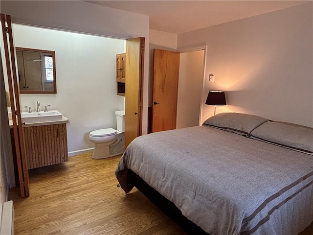 1237 County Highway 11, Davenport, NY 13860 - bedroom featuring wood finished floors and a baseboard heating unit