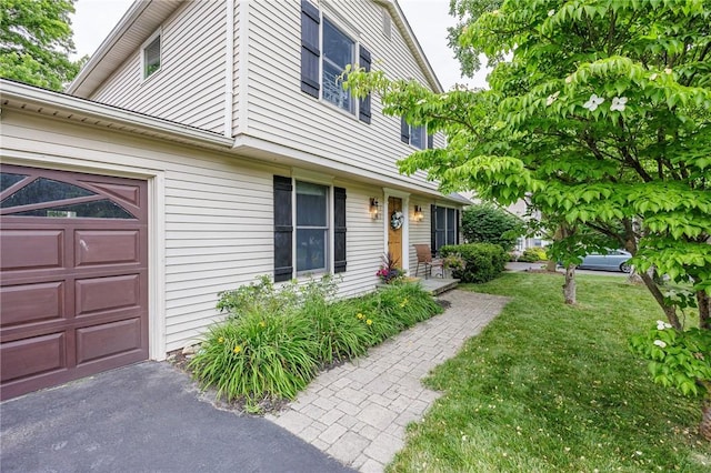 25 Killdeer Ln, Perinton, NY 14450 - view of side of home with a garage and a yard