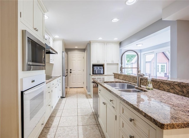 25 Killdeer Ln, Perinton, NY 14450 - kitchen with appliances with stainless steel finishes, under cabinet range hood, white cabinets, and recessed lighting