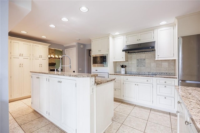 25 Killdeer Ln, Perinton, NY 14450 - kitchen with under cabinet range hood, appliances with stainless steel finishes, light tile patterned floors, recessed lighting, and backsplash