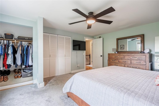 25 Killdeer Ln, Perinton, NY 14450 - bedroom featuring light colored carpet, two closets, and ceiling fan