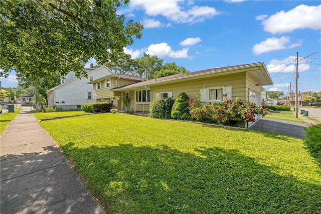 24 Gray St, Rochester, NY 14609 - tri-level home featuring a front lawn, asphalt driveway, and an attached garage