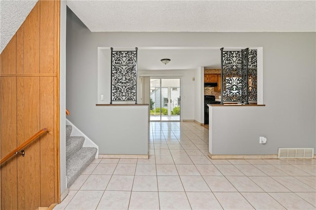 24 Gray St, Rochester, NY 14609 - foyer with light tile patterned floors, stairway, and a textured ceiling