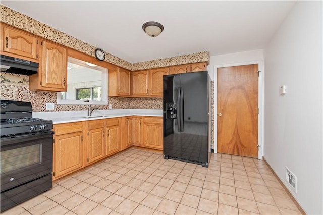 24 Gray St, Rochester, NY 14609 - kitchen featuring black appliances, under cabinet range hood, light countertops, and decorative backsplash