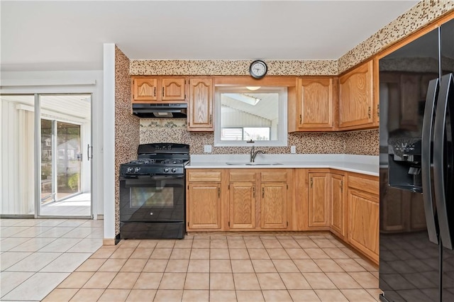 24 Gray St, Rochester, NY 14609 - kitchen with black appliances, exhaust hood, light tile patterned flooring, and plenty of natural light