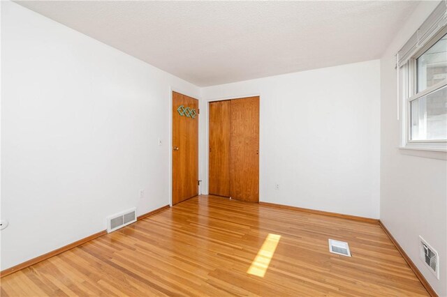 24 Gray St, Rochester, NY 14609 - empty room with light wood-type flooring and baseboards