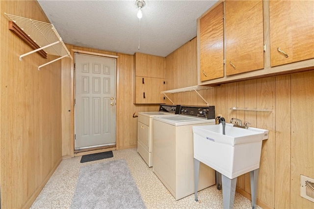 24 Gray St, Rochester, NY 14609 - laundry area featuring cabinet space, washing machine and clothes dryer, and a textured ceiling