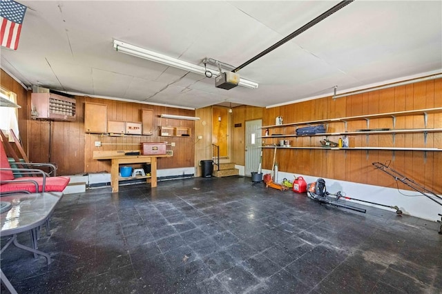 24 Gray St, Rochester, NY 14609 - garage with a garage door opener and wooden walls