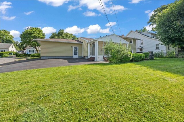 24 Gray St, Rochester, NY 14609 - rear view of house with a lawn, entry steps, and asphalt driveway
