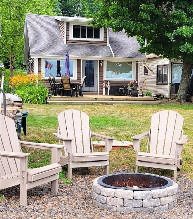 3904 Castle Point Rd, Starkey, NY 14842 - back of property with a shingled roof, an outdoor fire pit, and a lawn