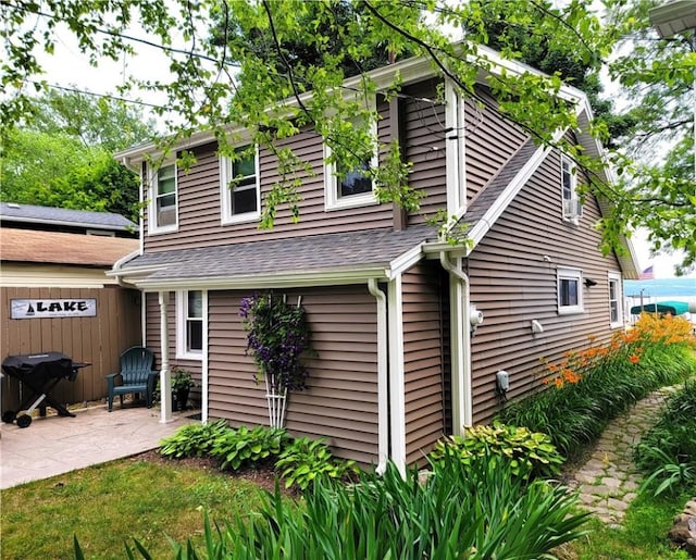 3904 Castle Point Rd, Starkey, NY 14842 - view of side of home featuring a patio and a shingled roof