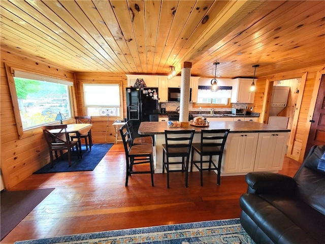 3904 Castle Point Rd, Starkey, NY 14842 - kitchen with black appliances, dark countertops, wooden ceiling, white cabinetry, and dark wood-style floors