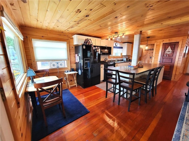 3904 Castle Point Rd, Starkey, NY 14842 - dining room featuring wooden ceiling, wood walls, and hardwood / wood-style flooring