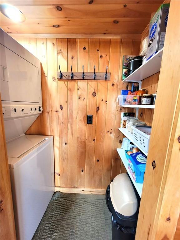 3904 Castle Point Rd, Starkey, NY 14842 - washroom with stacked washer / drying machine, wood walls, and wooden ceiling