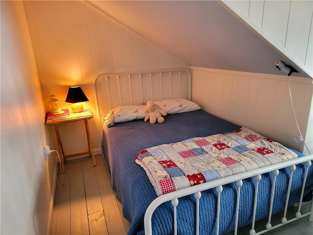 3904 Castle Point Rd, Starkey, NY 14842 - bedroom featuring hardwood / wood-style floors and vaulted ceiling