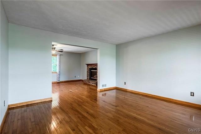 121 Ben Bar Cir, Whitestown, NY 13492 - unfurnished living room with hardwood / wood-style floors, a fireplace, and a ceiling fan
