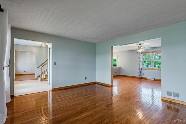 121 Ben Bar Cir, Whitestown, NY 13492 - spare room with hardwood / wood-style floors, stairs, ceiling fan, and a textured ceiling