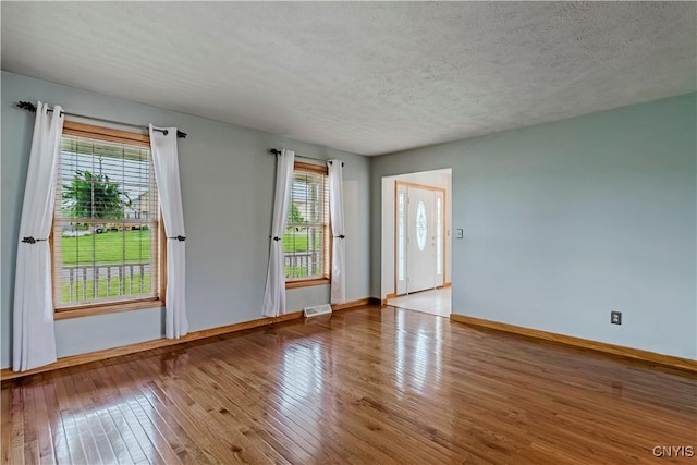 121 Ben Bar Cir, Whitestown, NY 13492 - unfurnished room featuring plenty of natural light, wood-type flooring, and a textured ceiling