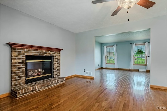 121 Ben Bar Cir, Whitestown, NY 13492 - unfurnished living room featuring wood finished floors, a ceiling fan, and a brick fireplace