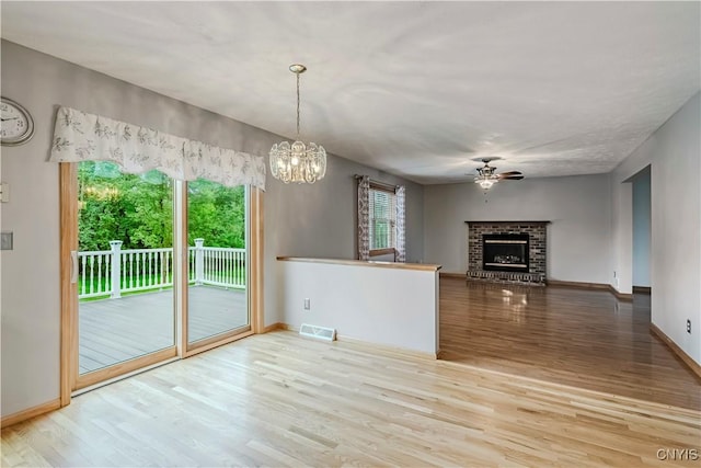 121 Ben Bar Cir, Whitestown, NY 13492 - unfurnished living room with wood finished floors, a ceiling fan, plenty of natural light, and a fireplace