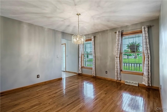 121 Ben Bar Cir, Whitestown, NY 13492 - unfurnished room featuring plenty of natural light, a chandelier, and wood finished floors